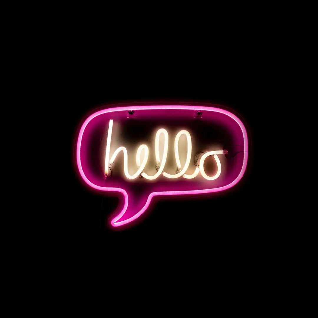 A neon Hello sign on a dark background - From Drew Beamer via Unsplash